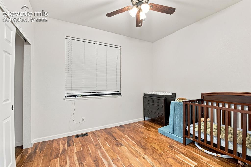 Image 11 of 18: Wood-finish flooring with a white wall finish