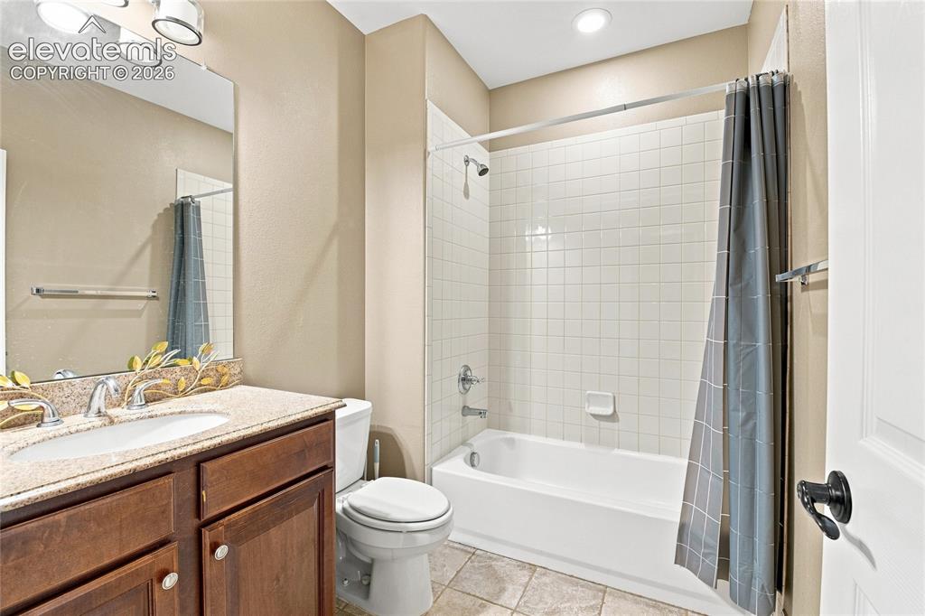 Image 14 of 18: Vanity with a light-toned countertop, a built-in sink, and wood-finish cabi