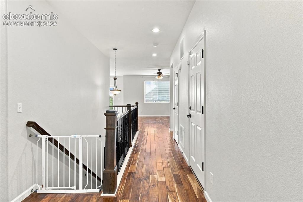 Image 3 of 18: Wood-finish flooring, recessed lighting, white interior doors, dark wood st