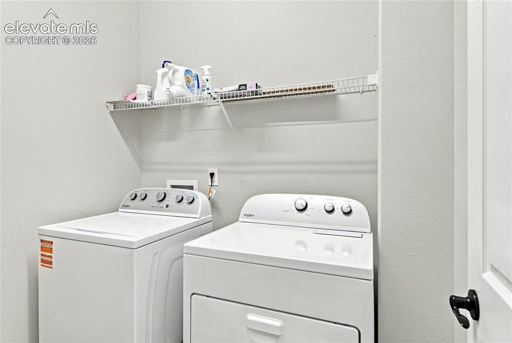 Image 9 of 18: Laundry area featuring a wire shelving unit