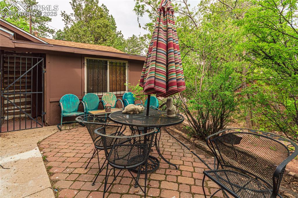 Image 10 of 23: View of patio with outdoor dining space