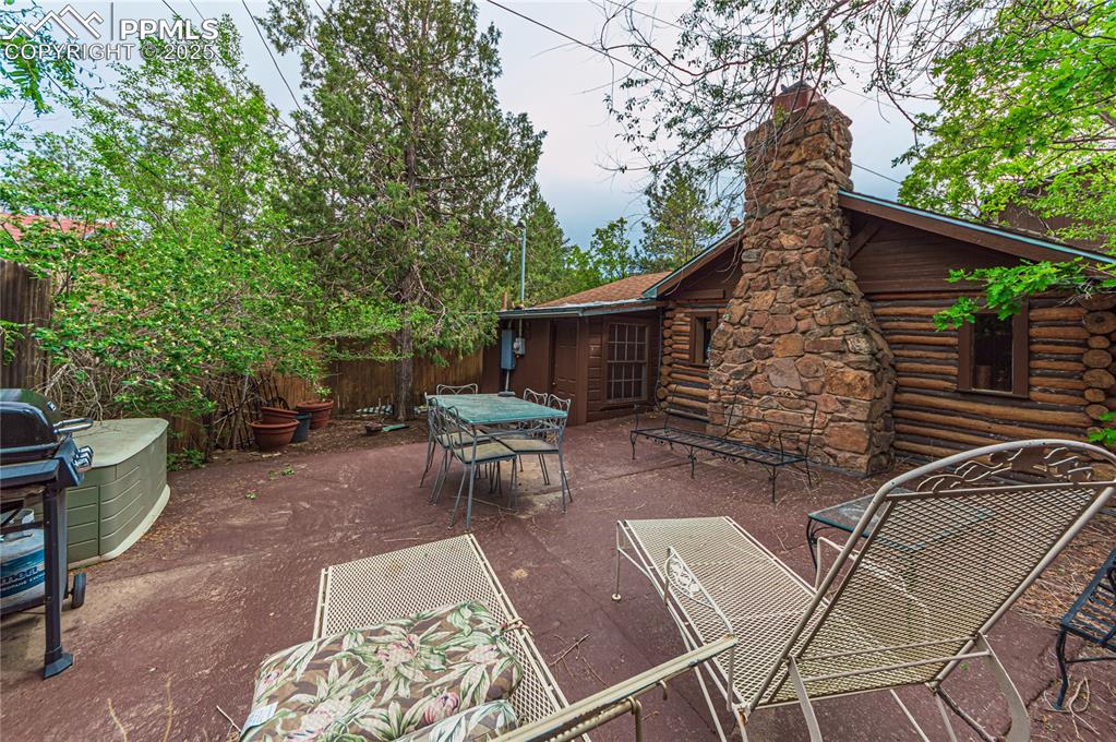 Image 15 of 23: View of patio with grilling area and outdoor dining space