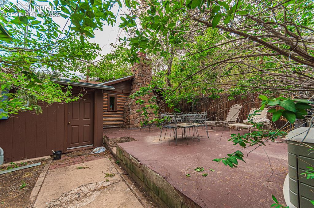 Image 16 of 23: View of patio with outdoor dining area