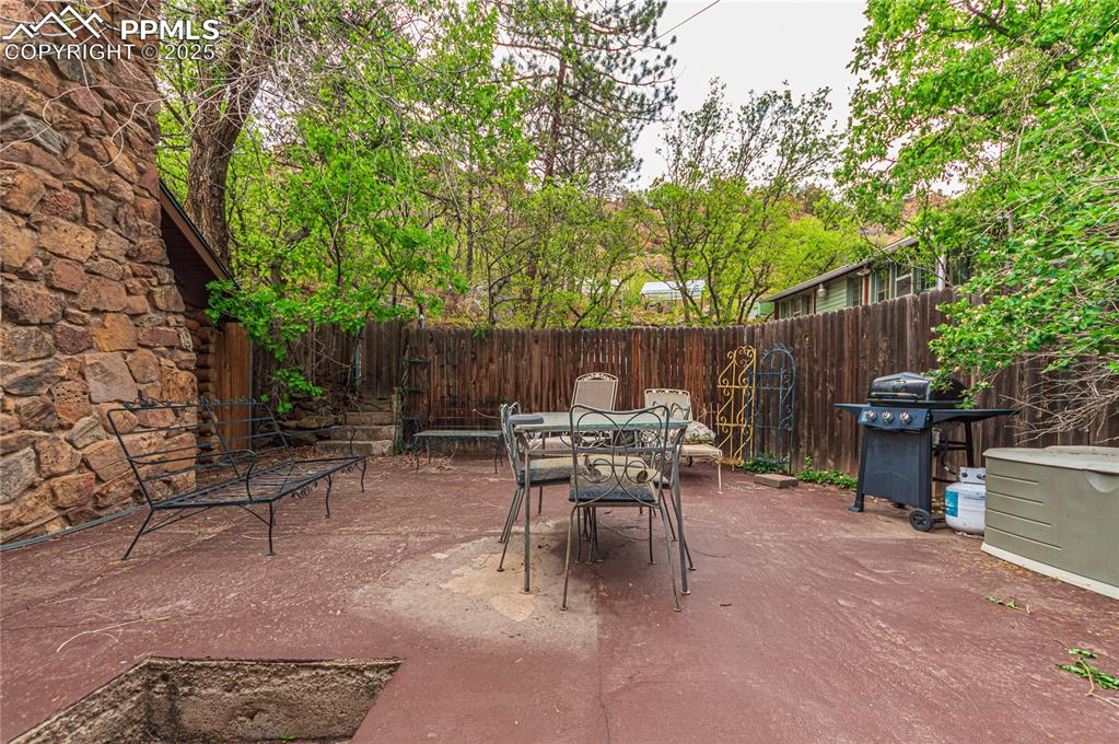 Image 18 of 23: Fenced backyard featuring outdoor dining space, a patio, and area for grill