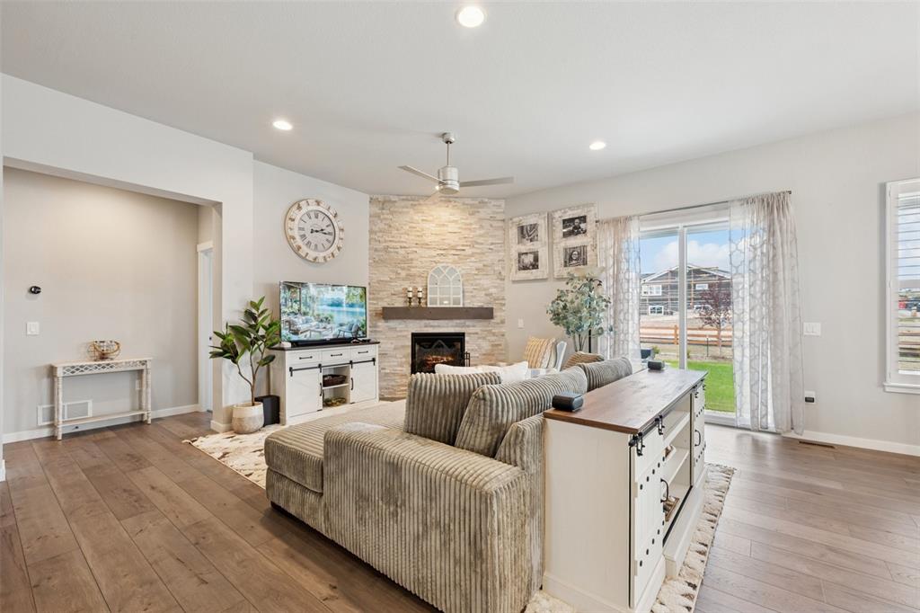 Image 15 of 44: Full height stone fireplace and walk out to large back yard!