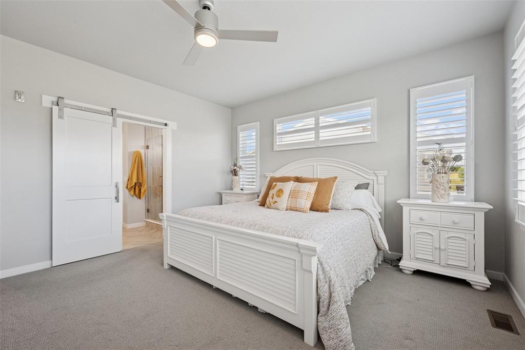 Image 18 of 44: Private master retreat with barn door to bath and upgraded carpet!