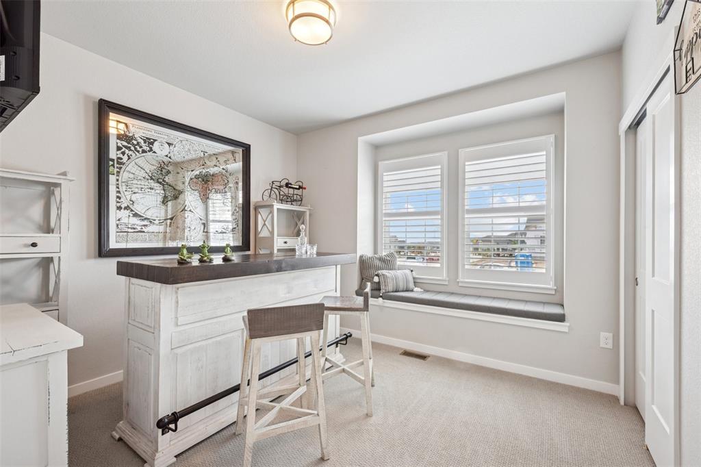 Image 22 of 44: Main level bedroom with plantation shutters!