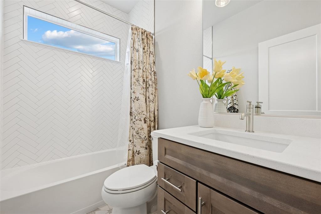 Image 24 of 44: Charming main level laundry with counter and sink!