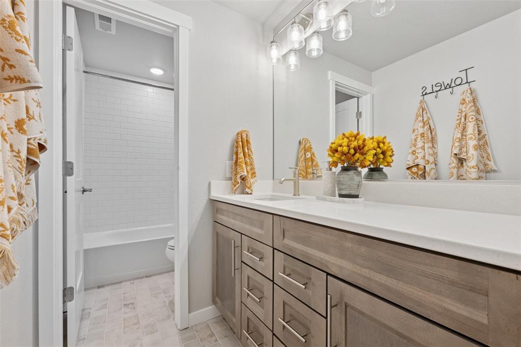 Image 34 of 44: Third bath with quartz counters and separate tub/toilet area!