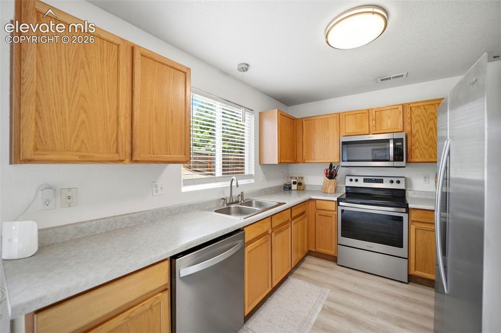 Image 10 of 38: Stainless steel appliances and pantry