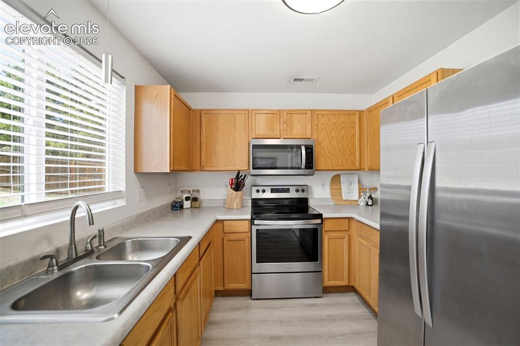 Image 12 of 38: Stainless steel appliances and pantry