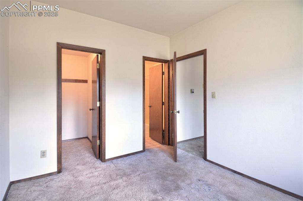 Image 10 of 46: Lower level bedroom, closet and bathroom.