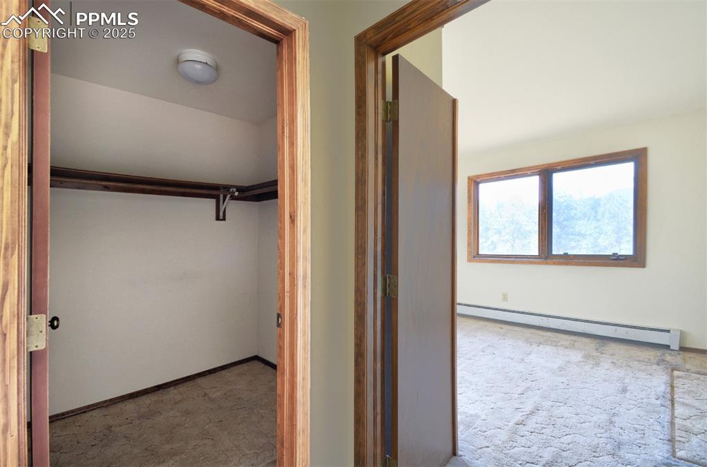 Image 31 of 46: Off Primary bedroom, closet and entry in to an office or den area.