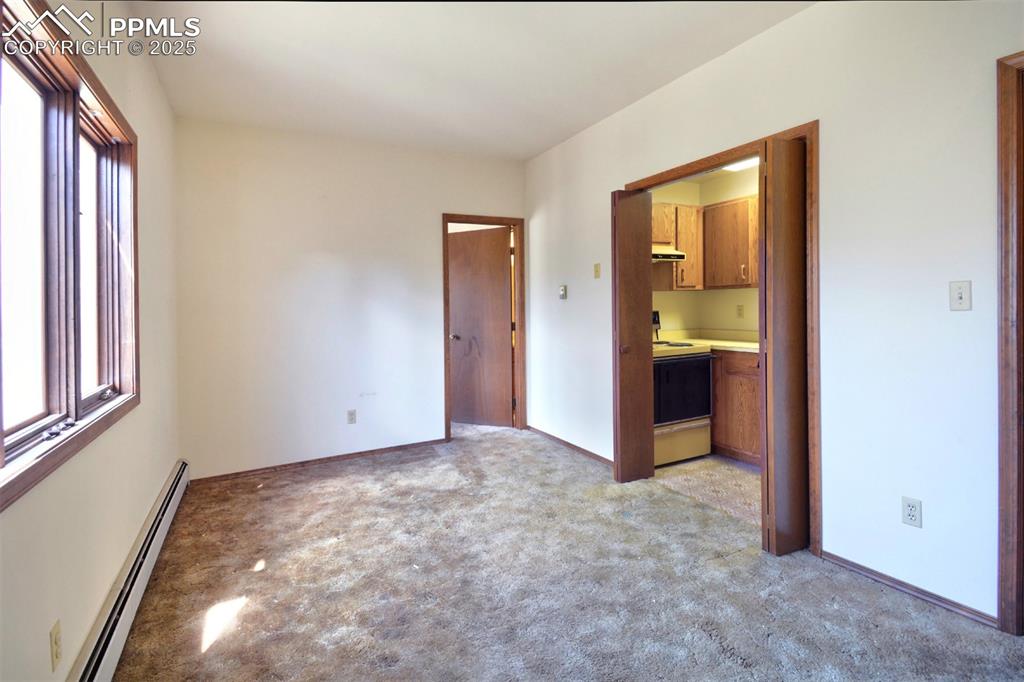 Image 5 of 46: Lower level living room, kitchen and bathroom.