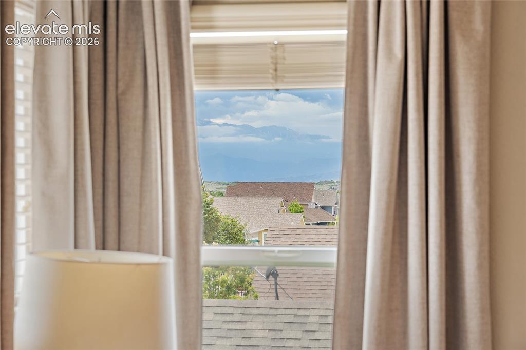 Image 17 of 42: Pikes Peak Views from primary bedroom