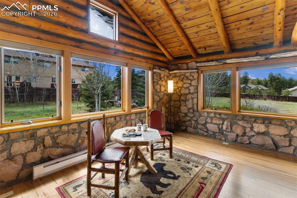Image 19 of 48: Gorgeous wood-burning fireplace with stone mantel