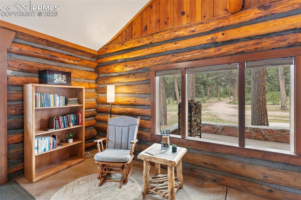Image 7 of 48: Rustic log detailing in the inviting entry