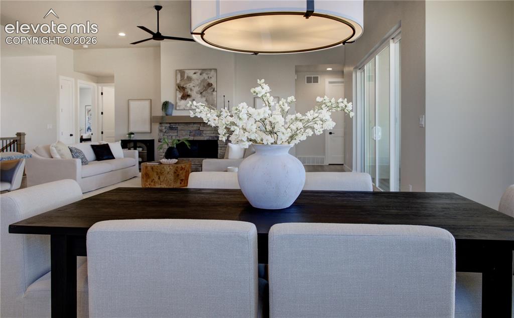 Image 10 of 35: Dining space featuring a dark wood-finish table with upholstered chairs, un