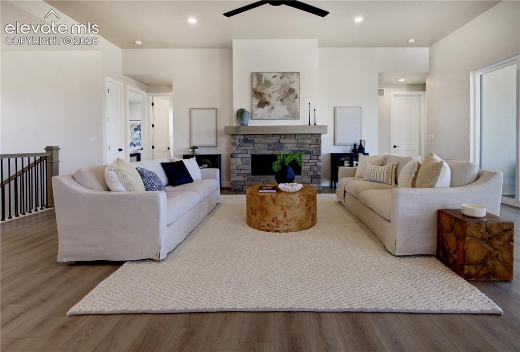 Image 11 of 35: Spacious living area featuring high ceilings and wood-finish flooring