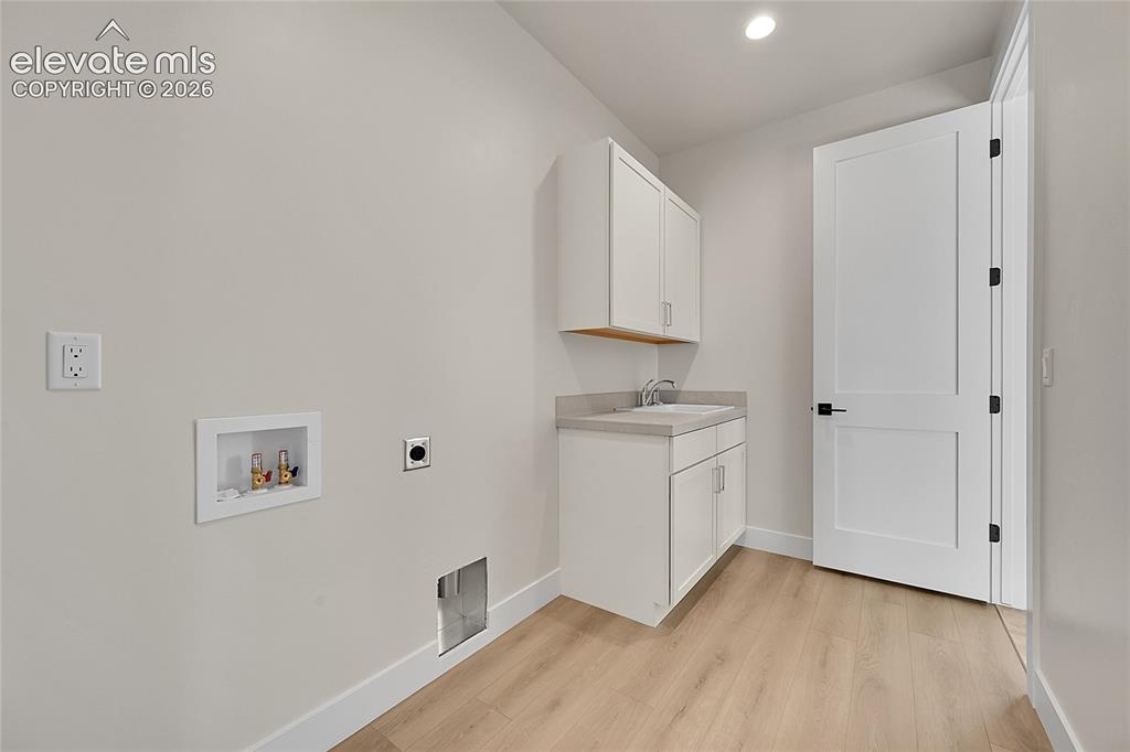 Image 21 of 35: Laundry room featuring a built-in sink, main floor
