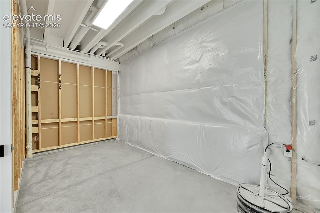 Image 31 of 35: Unfinished basement space featuring exposed wood framing, concrete flooring