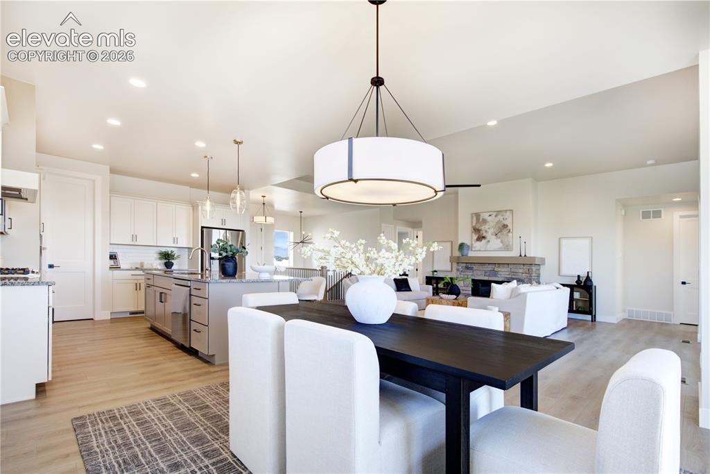 Image 4 of 35: Expansive open-concept living space featuring a modern kitchen, dining area