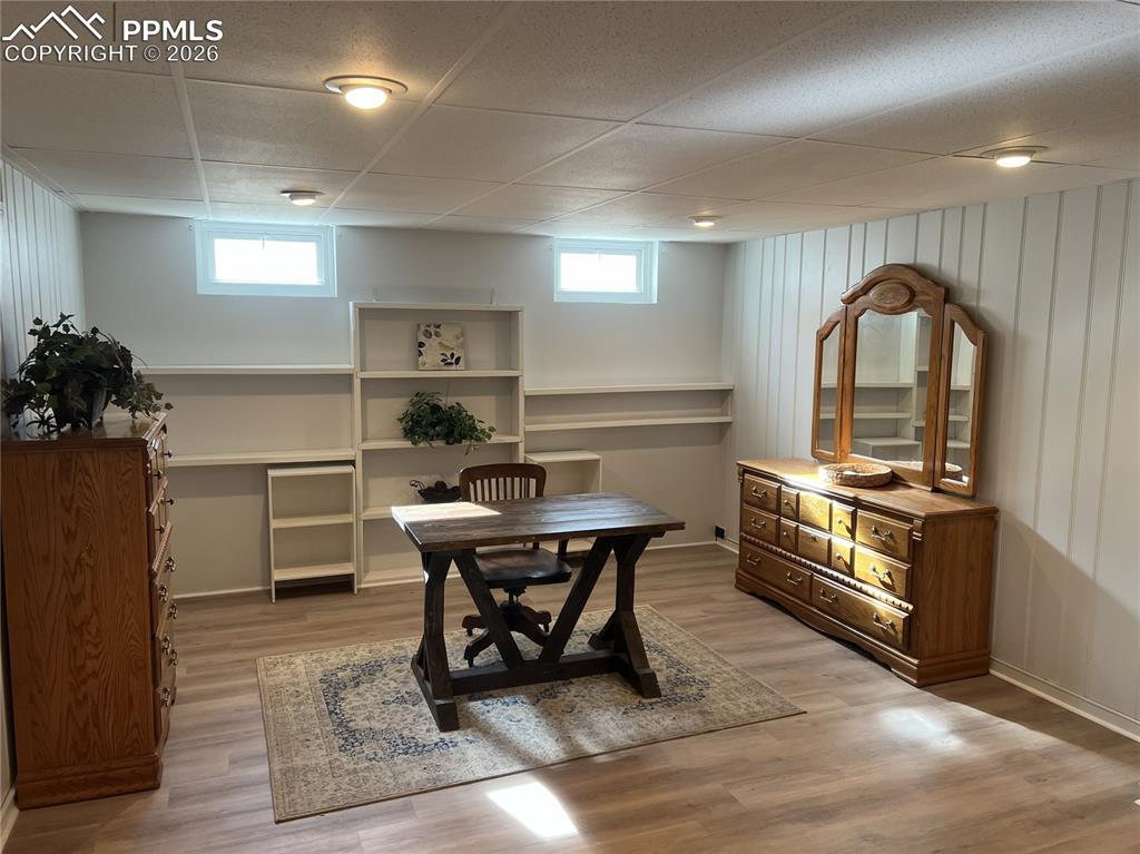 Image 14 of 25: Huge basement family room with newer LVP flooring and built-in shelving!