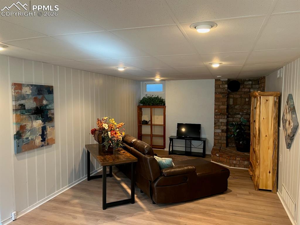 Image 15 of 25: Brick area for adding a wood burning stove to basement family room