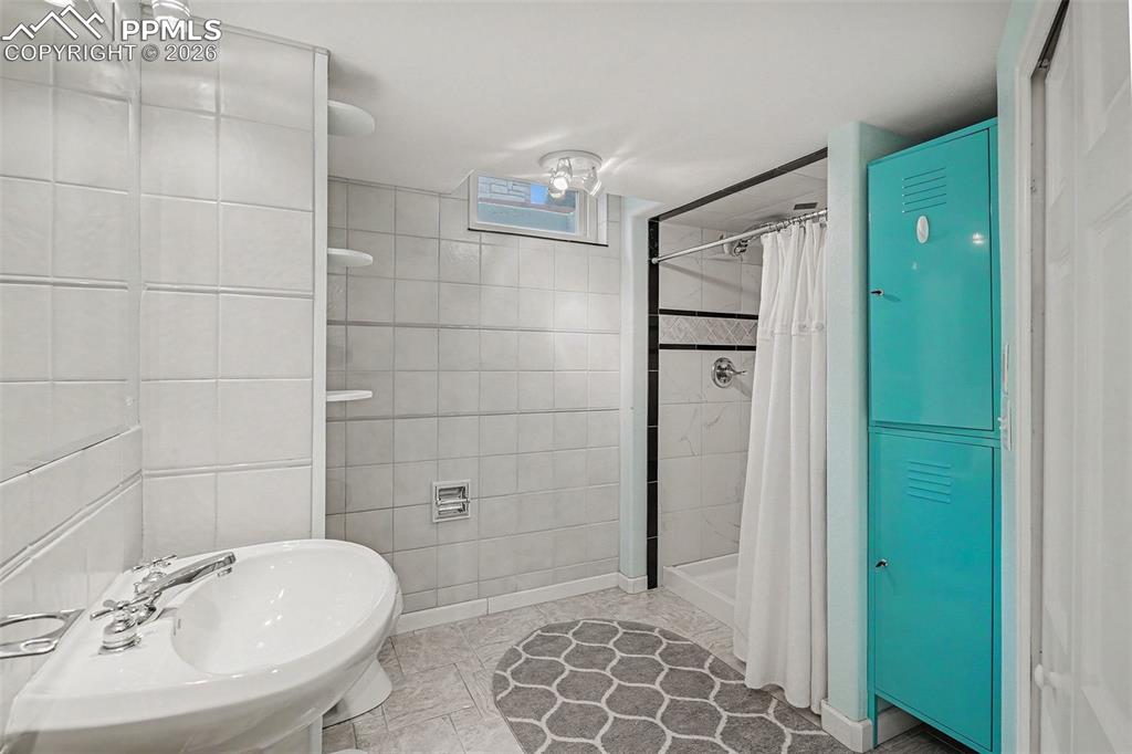 Image 16 of 25: Updated, modern bathroom in basement