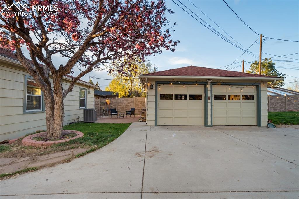 Image 23 of 25: Relax on the brick patio that extends from the house to the garage!