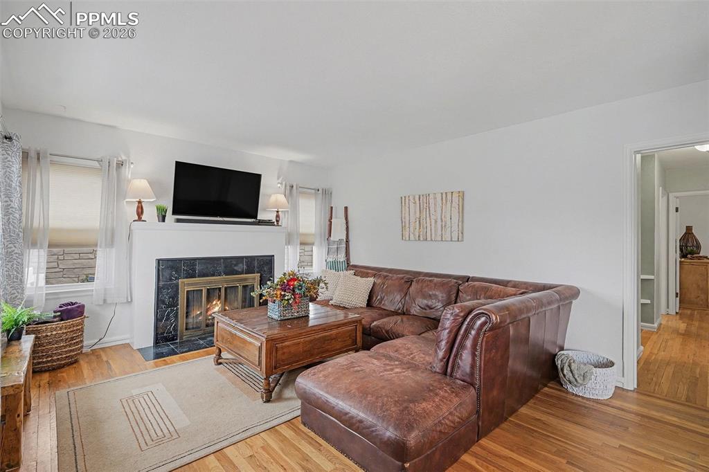 Image 4 of 25: Cozy wood burning fireplace