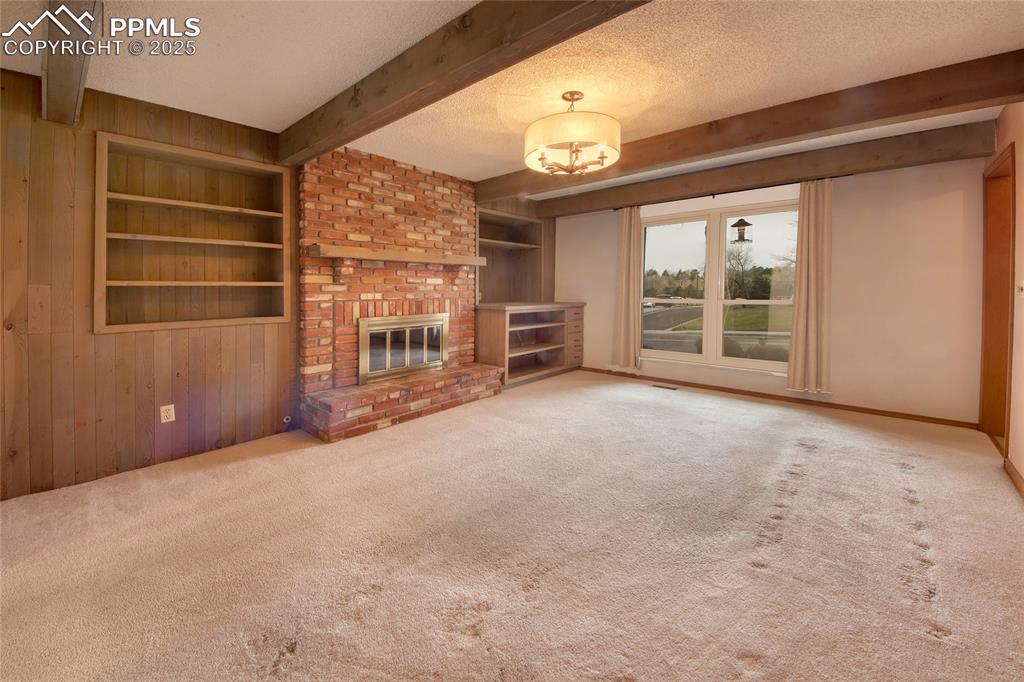 Image 16 of 48: Cozy great room with built-in bookshelves and gas fireplace 
