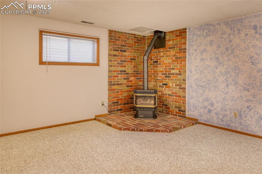 Image 28 of 48: Family room with gas stove 