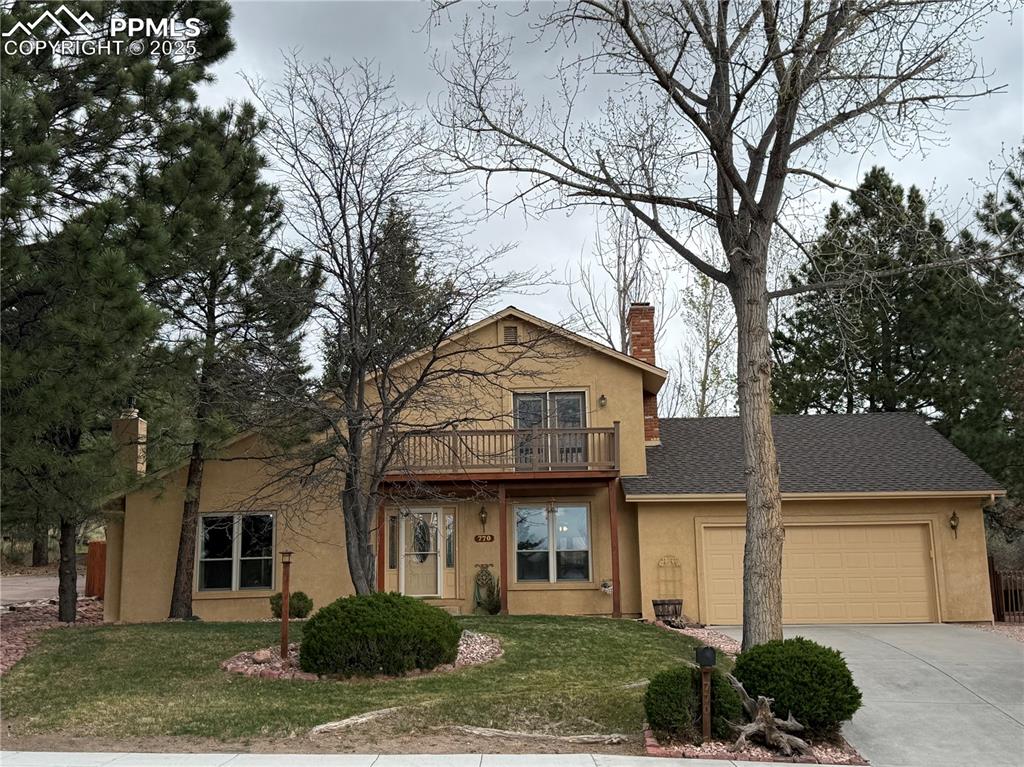 Image 3 of 48: View of front of home with stucco siding, a chimney, an attached garage, dr