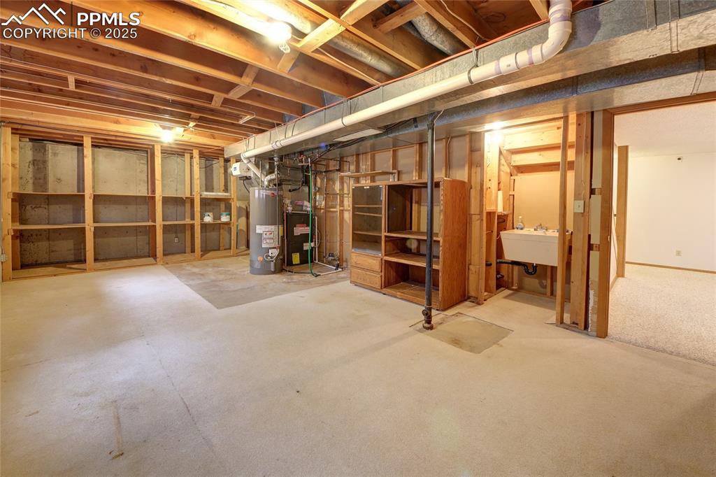 Image 34 of 48: Huge utilities room with storage and sink 