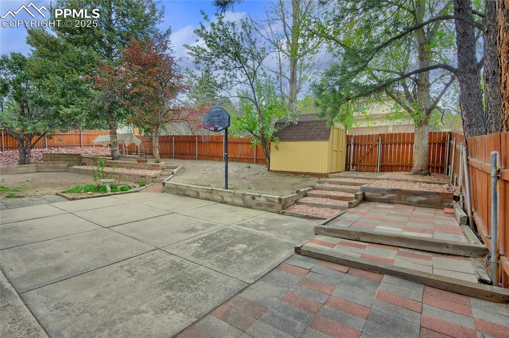 Image 35 of 48: View of patio / terrace featuring a storage shed, and a fenced backyard