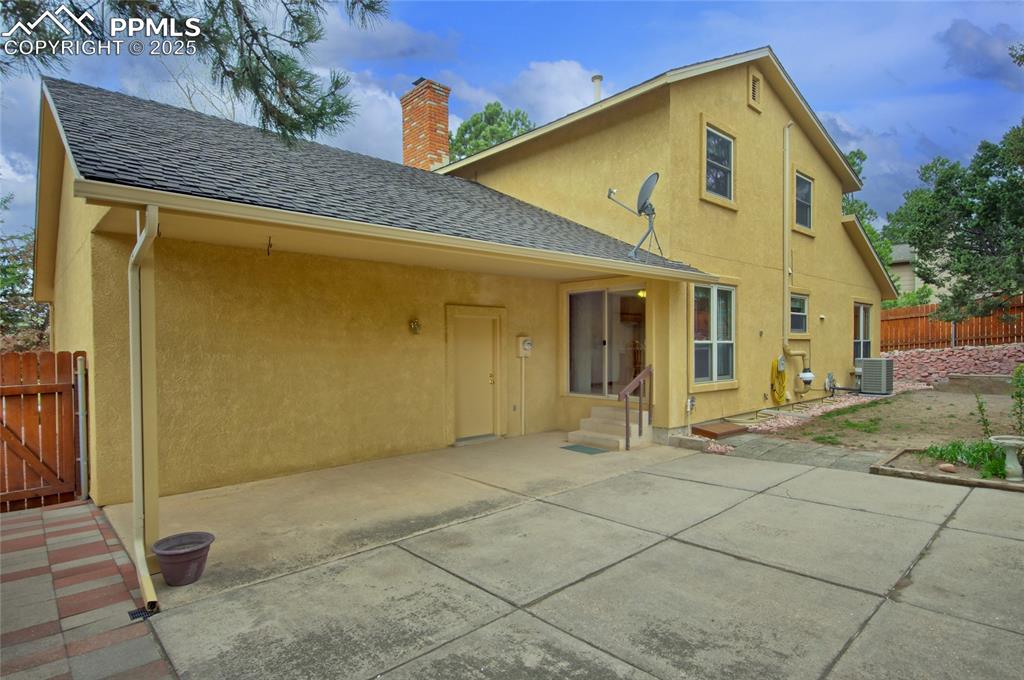 Image 36 of 48: Rear view of house featuring large covered patio