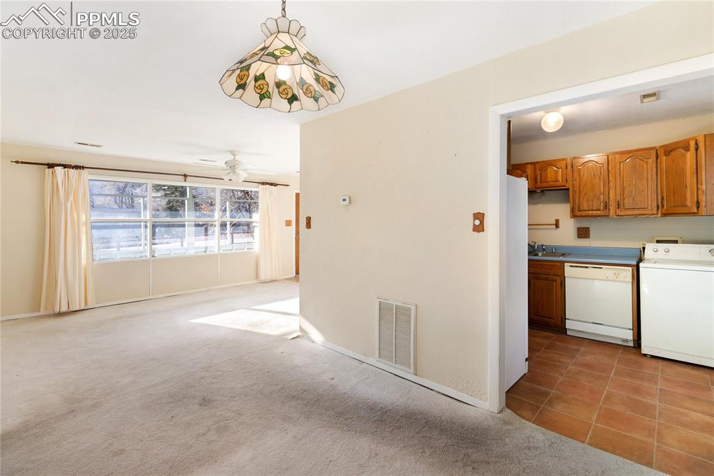 Image 23 of 44: Dining room off of the kitchen - open to the living room