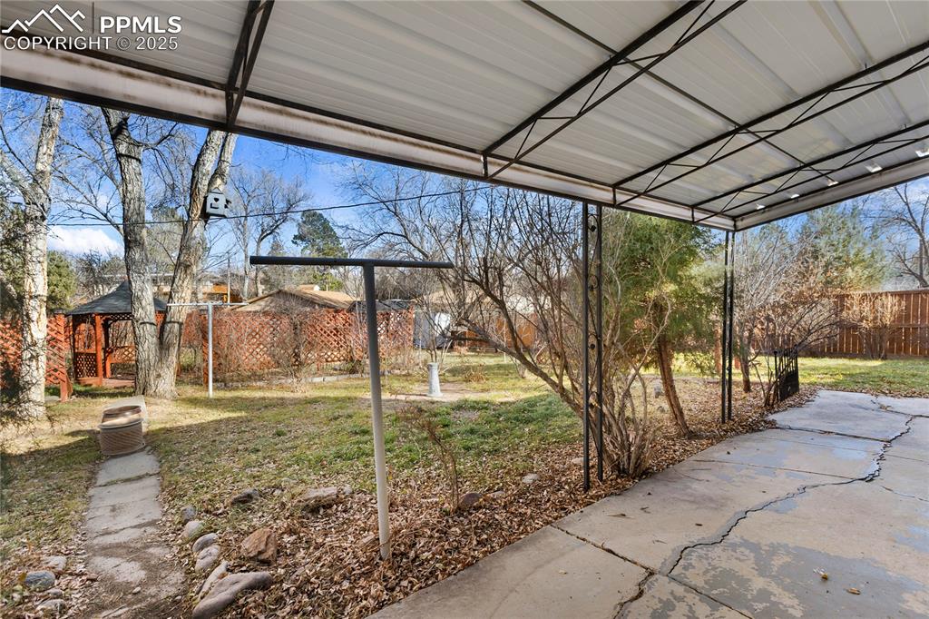Image 9 of 44: Covered concrete patio.
