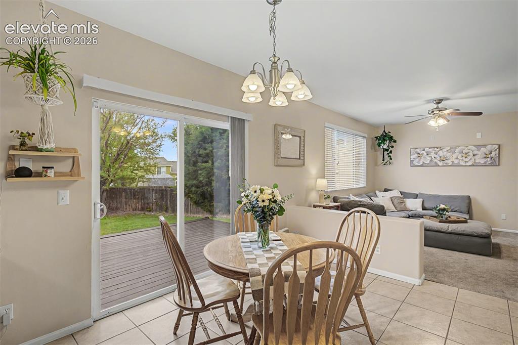 Image 11 of 45: Open-concept kitchen and dining area and a sliding glass door to the outdoo