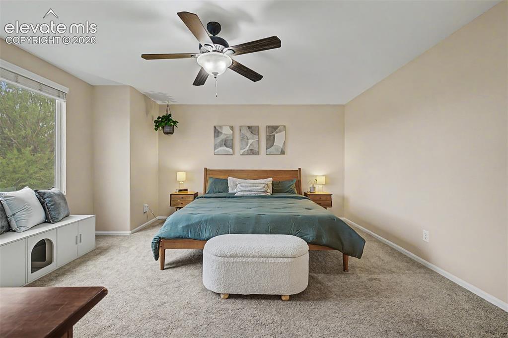 Image 26 of 45: Oversized primary suite includes a large picture window looking into the ba