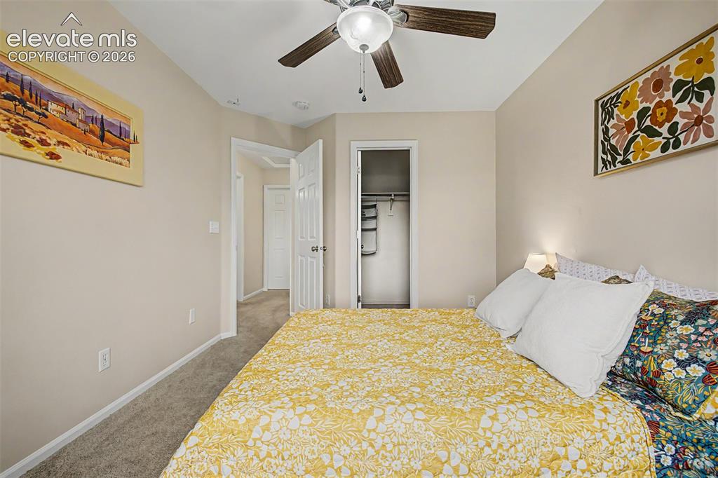Image 31 of 45: Guest bedroom with walk-in closet and large window is perfect for company!