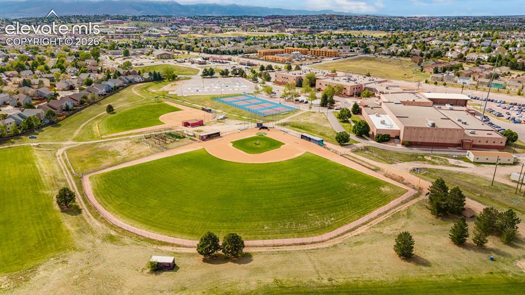 Image 43 of 45: Expansive athletic complex featuring a track and field, baseball diamonds,