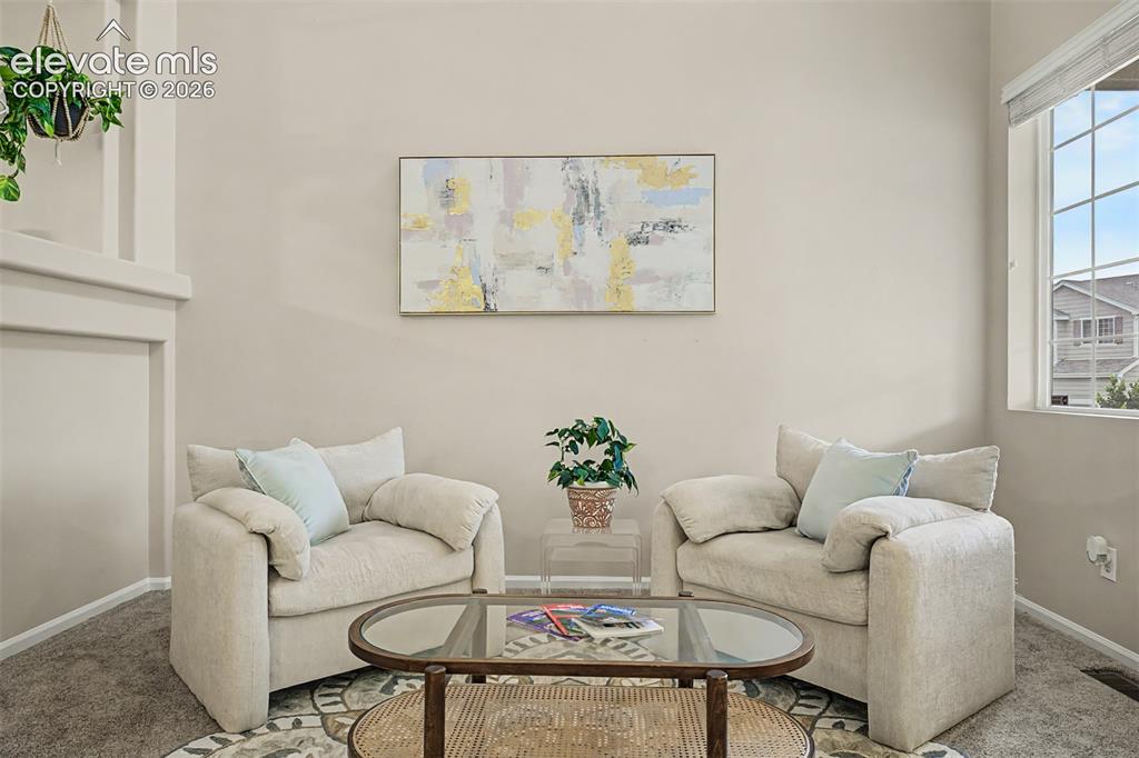 Image 5 of 45: Living area featuriing soaring vaulted ceilings and ample natural light