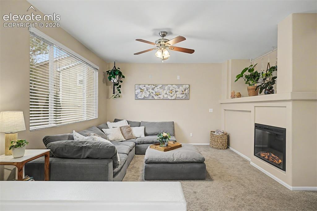 Image 6 of 45: Living area featuriing soaring vaulted ceilings and ample natural light