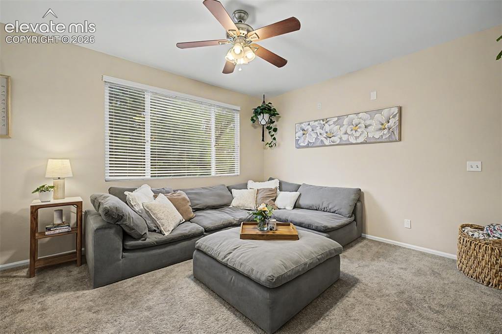 Image 7 of 45: Inviting living space featuring a built-in electric fireplace and light-ton