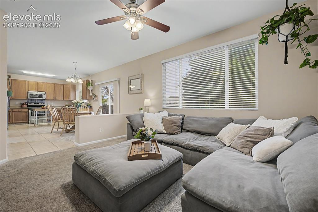 Image 8 of 45: Family room has a large window lookiing into the backyard and a built-in f