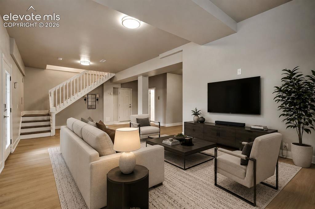 Image 31 of 48: Open-concept living area featuring wood-finish flooring, recessed ceiling l