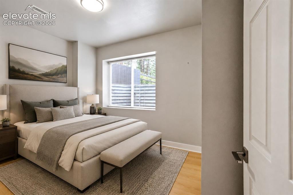 Image 35 of 48: Bedroom featuring light wood-finish flooring, a window with horizontal blin