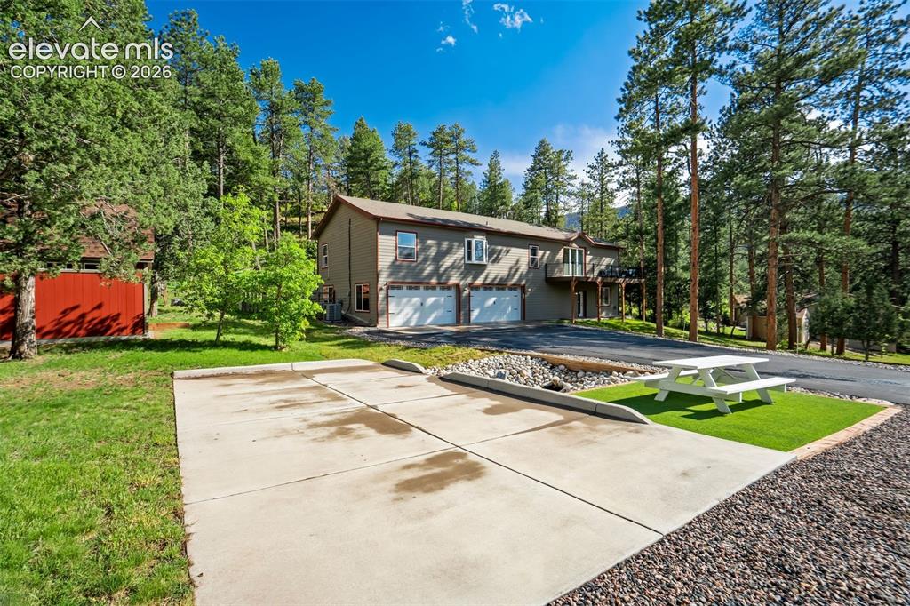 Image 44 of 48: 5 parking spaces, attached oversized 4 car garage, storage shed with space 